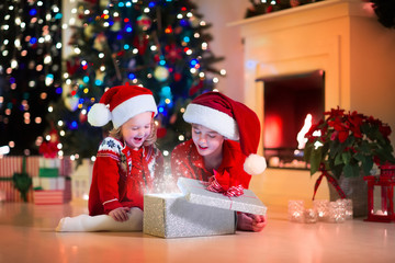 Fototapeta na wymiar Kids opening Christmas presents