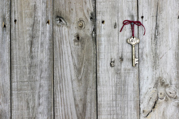 Skeleton key hanging on rustic wood door