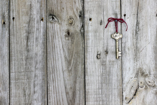 Skeleton key hanging on rustic wood door