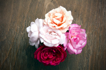 bouquet of roses on a wooden background