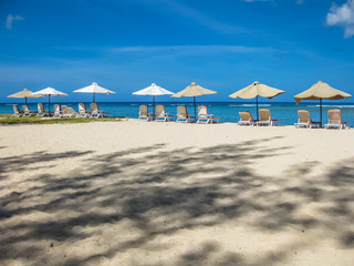 Sun umbrellas on white sand