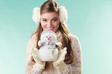 Smiling cute woman with little snowman. Winter.