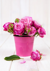 Pink roses(peony) in vase on white wooden background. flowers