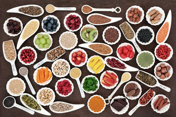 Large Superfood Collection. Large health and superfood collection in porcelain dishes over lokta paper background. High in minerals, vitamins and antioxidants.
