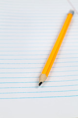 Yellow pencil on notebook