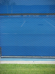 blue fence with green grass abstract design background