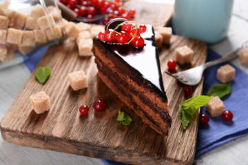 Tasty chocolate cake with berries on table close up
