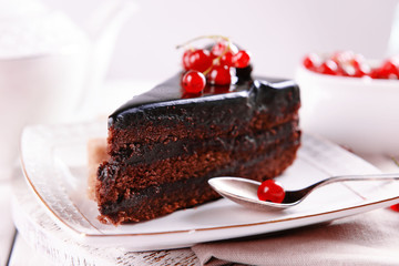 Tasty chocolate cake with berries on table close up
