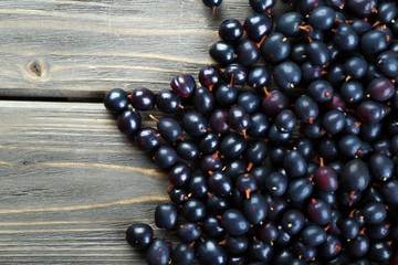 Heap of wild black currant on wooden table close up