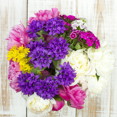 bouquet of colorful flowers on white wooden planks