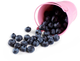 Tasty ripe blueberries in bucket on table close up