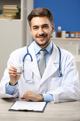 Doctor holding bottle with medical cannabis close up