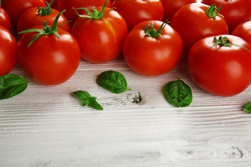 Red tomatoes on wooden background