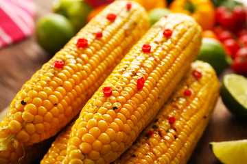 Tasty grilled corn with vegetables, close up
