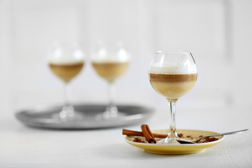 Wine glass with jelly on table, on light background