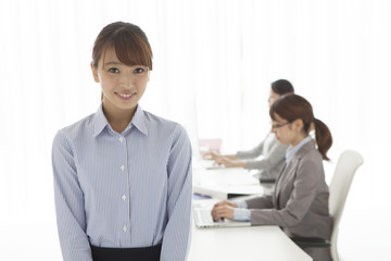 Women's portrait working in office