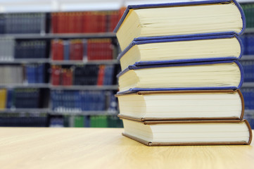 stacking books on library table