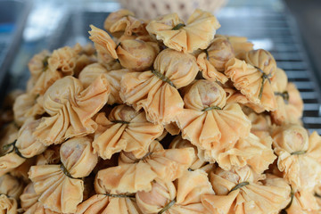 A pile of deep fried shrimp dumpling on a sieve