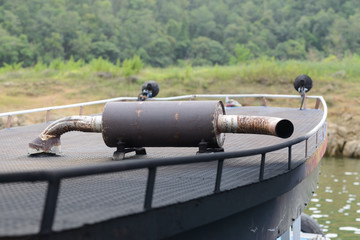 Rusted exhaust pipe on a roof top of a boat