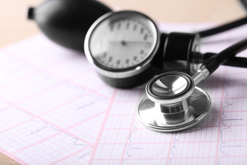 Blood pressure meter, digital tablet and stethoscope, on wooden background