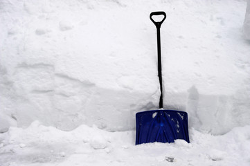 snow shovel against snow pile