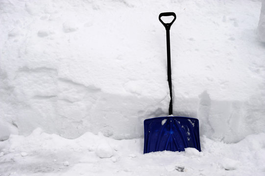 snow shovel against snow pile
