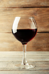 Glass of red wine on wooden table