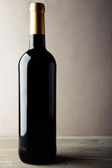 Bottle of red wine on wooden table