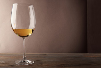 Glass of white wine on wooden table