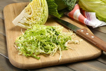 Cut savoy cabbage on wooden cutting board