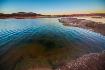 Deep blue green water and beautiful warm sunset Lake Powell Utah