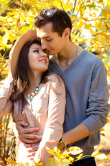 Fototapeta premium Happy couple hugging on the autumn background