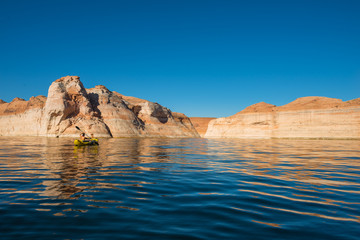 Fototapeta na wymiar kayaker paddling the calm waters of Lake Powell Utah