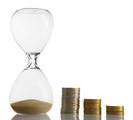 Hourglass with coins isolated on white