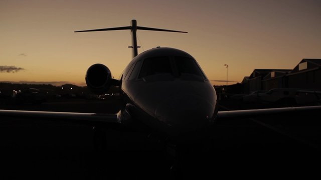 Parked private jet at sunrise.