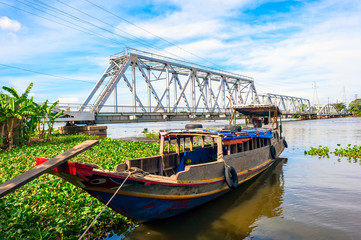 Wooden boat anchoring on Saigon river in Hochiminh city, Vietnam.