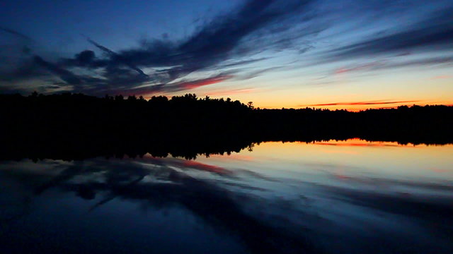 Still waters under a subdued sunset in the Wisconsin northwoods.