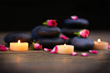 Obraz na płótnie Canvas Spa stones and candles on dark background