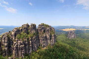 Fototapeta na wymiar Panorama with Group of rocks Schrammsteine and Falkenstein seen from viewing point in Saxon Switzerland