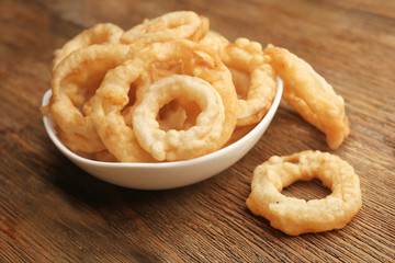Chips rings in bowl on wooden background