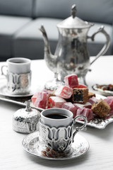 Antique tea-set with Turkish delight on table close-up