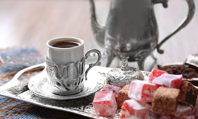 Antique tea-set with Turkish delight on table close-up