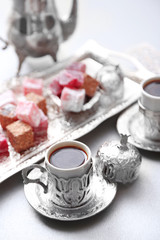 Antique tea-set with Turkish delight on table close-up