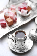 Antique tea-set with Turkish delight on table close-up