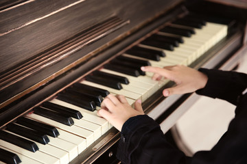 Fototapeta na wymiar Close up of little girl hands piano playing