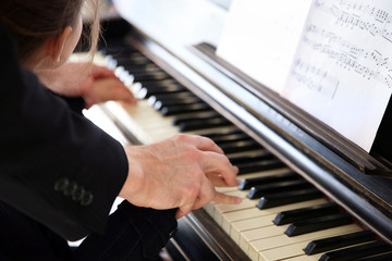 Close up of musician man and girl hands piano playing