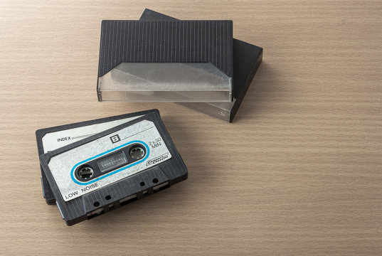 Vintage hi-end audio cassette tape on wooden table.
