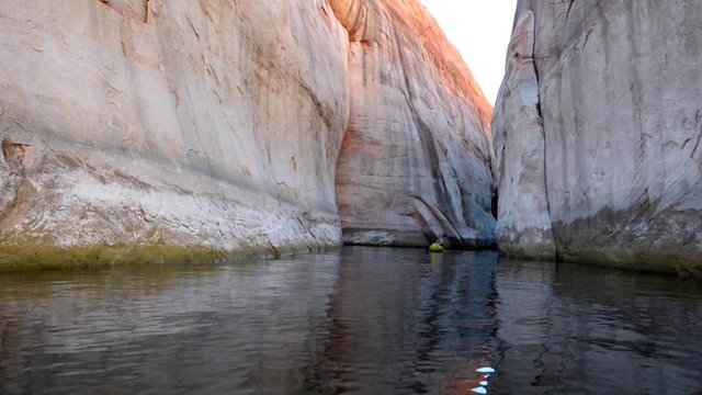 Kayaker in the narrows Lost Eden Canyon Lake Powell near Halls Crossing