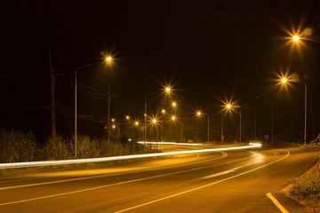 Night Road at suburban with the light trails car 