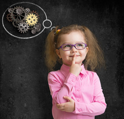 kid girl in glasses with bright idea standing near school